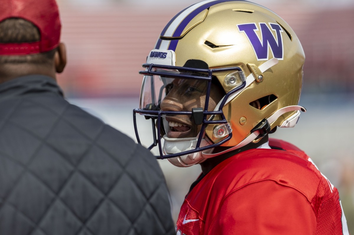 Feb 1, 2024; Mobile, AL, USA; National quarterback Michael Penix Jr of Washington (9) talks with National quarterbacks coach Israel Woolfork of the Arizona Cardinals during practice for the National team at Hancock Whitney Stadium.